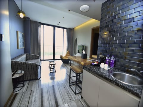 Hill View Suite with Balcony at Residences | Living area | TV