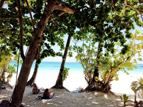 On the beach, white sand, beach towels, beach massages