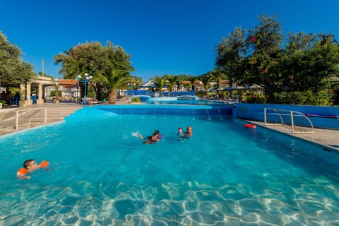 Seasonal outdoor pool, open 9:00 AM to 7:00 PM, pool umbrellas