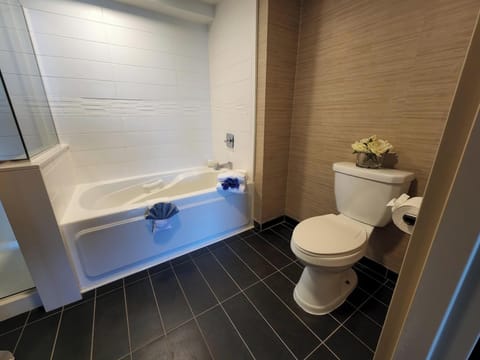 Deluxe Room | Bathroom | Rainfall showerhead, designer toiletries, towels