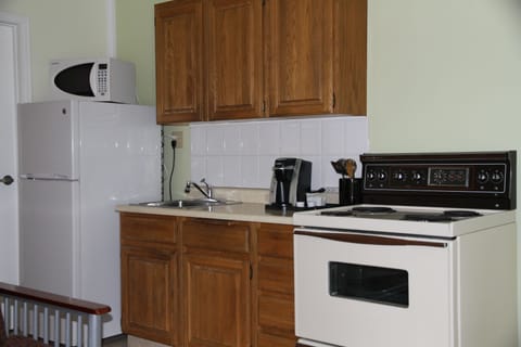 Fridge, microwave, coffee/tea maker, cookware/dishes/utensils