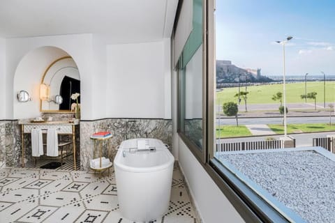 Suite, 1 King Bed | Bathroom | Separate tub and shower, eco-friendly toiletries, hair dryer, bathrobes