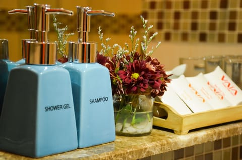 Designer toiletries, hair dryer, slippers, towels