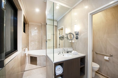 Luxury Suite, 1 Queen Bed, Jetted Tub | Bathroom | Designer toiletries, hair dryer, towels, soap