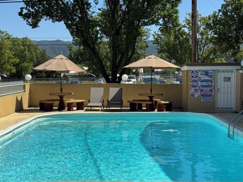 Outdoor pool, open 8:00 AM to 9:00 PM, pool umbrellas