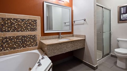 Suite, 1 King Bed, Jetted Tub | Bathroom | Combined shower/tub, free toiletries, hair dryer, towels