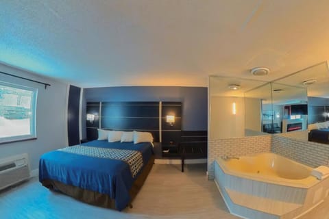 1 King Suite Jacuzzi, Non Smoking | Hypo-allergenic bedding, in-room safe, laptop workspace, blackout drapes