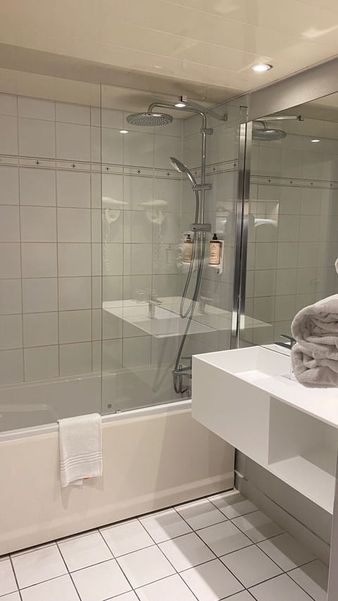 Bathtub, eco-friendly toiletries, hair dryer, towels