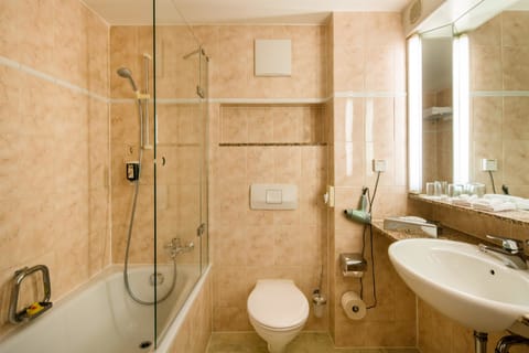 Bathtub, eco-friendly toiletries, hair dryer, towels