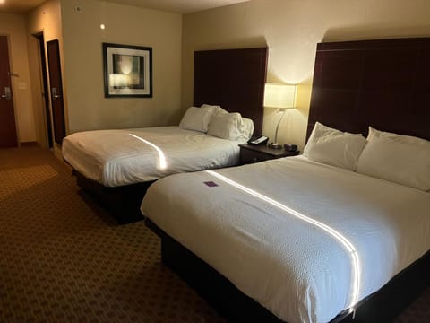 Premium bedding, desk, laptop workspace, blackout drapes