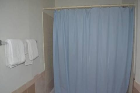 Basic Single Room, 1 Queen Bed | Bathroom | Combined shower/tub, hair dryer, towels