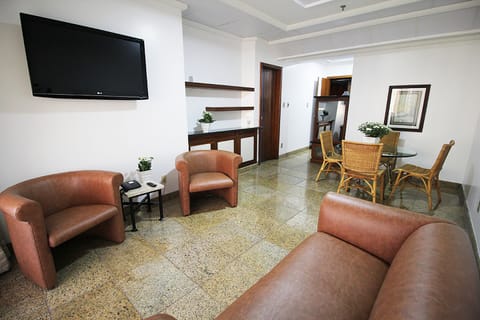 Deluxe Suite | Living area | 42-inch LCD TV with cable channels, TV