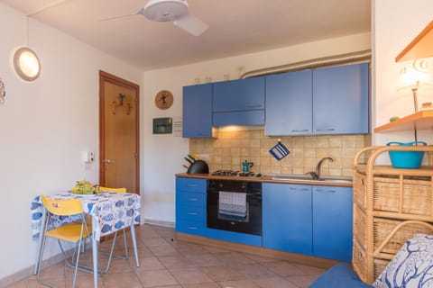 Family Apartment, 1 Bedroom (Casa Emozione With Shared Pool) | Private kitchen | Oven, stovetop, cookware/dishes/utensils, dining tables