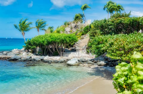 On the beach, white sand, sun loungers, beach towels