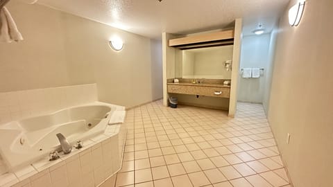 Deluxe Room, 1 King Bed, Non Smoking, Hot Tub | Bathroom | Hair dryer, towels