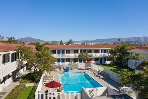 Outdoor pool, open 9:00 AM to 9:00 PM, pool umbrellas