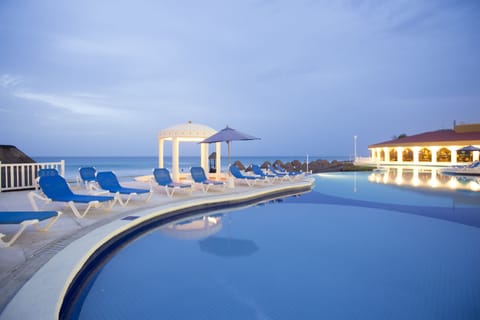 Outdoor pool, open 7:00 AM to 10:00 PM, pool umbrellas, sun loungers