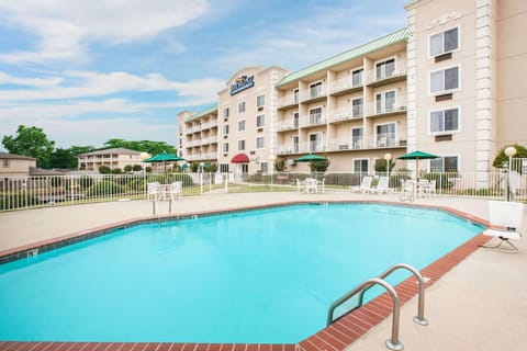 Seasonal outdoor pool, open 8:00 AM to 10:00 PM, pool umbrellas