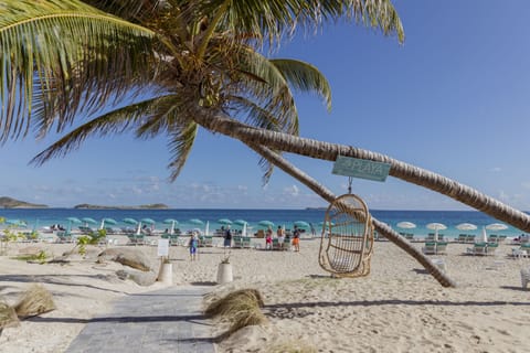 On the beach, white sand, sun loungers, beach umbrellas