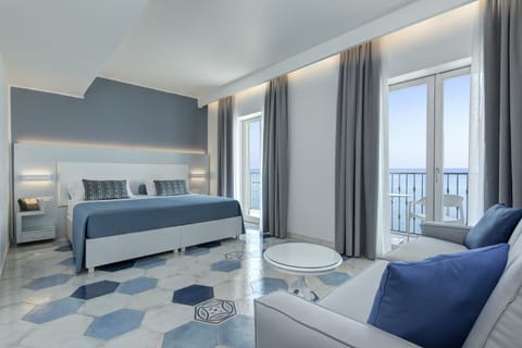 Superior Quadruple Room, Partial Sea View | Premium bedding, minibar, in-room safe, individually decorated