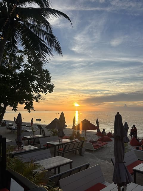 On the beach, white sand, sun loungers, beach umbrellas