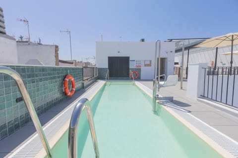 Seasonal outdoor pool, open 11:00 AM to 9:00 PM, pool umbrellas