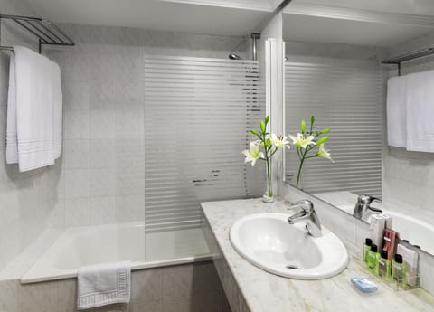 Bathtub, eco-friendly toiletries, hair dryer, towels