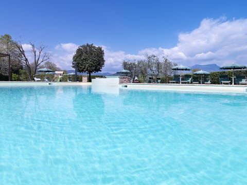 Seasonal outdoor pool, open 9:00 AM to 8:00 PM, pool umbrellas