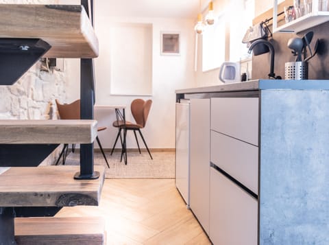 City Apartment | Private kitchen | Mini-fridge, stovetop, electric kettle, dining tables