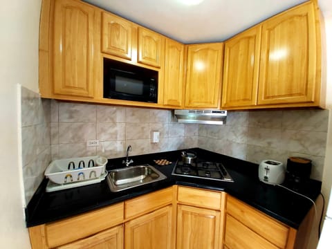 Standard Studio, 1 King Bed | Private kitchen | Fridge, microwave, stovetop, coffee/tea maker