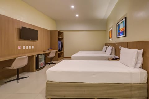 Deluxe Triple Room | Minibar, in-room safe, desk, soundproofing