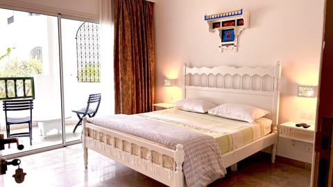 Deluxe Double Room, Garden Area | Minibar, desk, laptop workspace, bed sheets