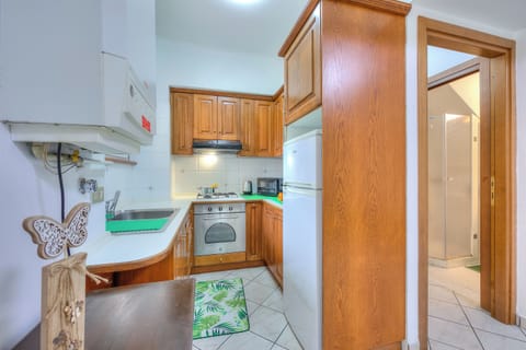 Family Apartment, 2 Bedrooms (Leonardo House Garden Stresa Center) | Private kitchen | Fridge, microwave, oven, stovetop