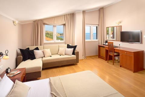 Classic Triple Room, Partial Sea View | Minibar, in-room safe, desk, cribs/infant beds