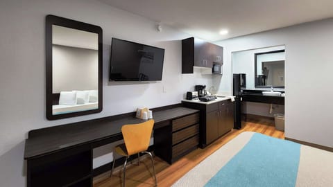 Desk, laptop workspace, blackout drapes, iron/ironing board