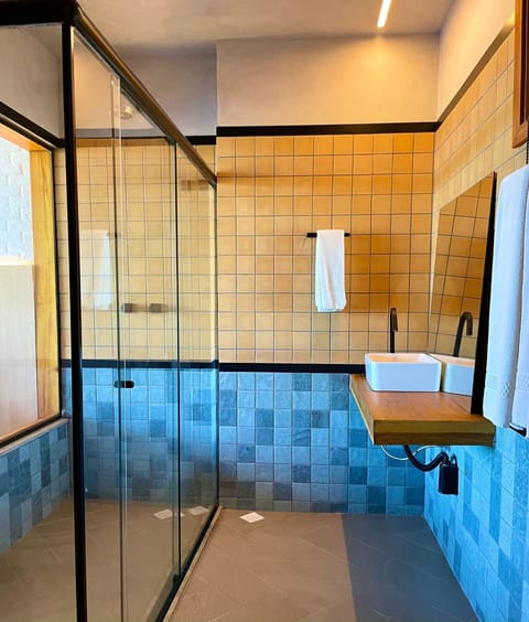 Deluxe Seafront | Bathroom | Shower, hair dryer, towels