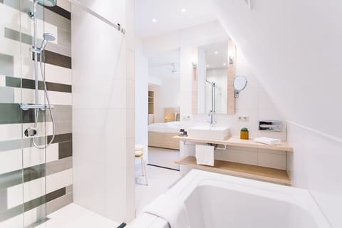 Deluxe Suite | Bathroom | Designer toiletries, hair dryer, bathrobes, towels