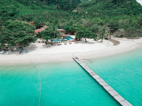 On the beach, white sand, sun loungers, beach towels