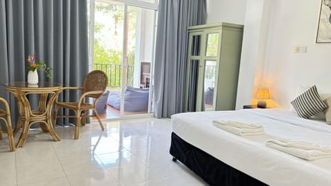 Deluxe Triple Room, Terrace, Pool View | Living area | 24-inch flat-screen TV with satellite channels, TV, books