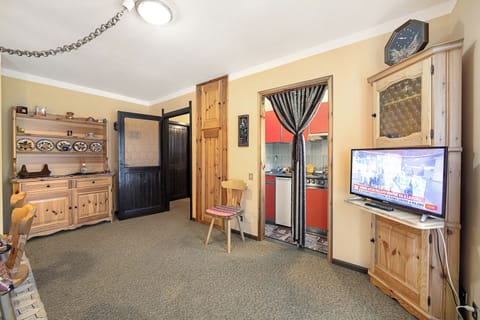 Family Apartment, 1 Bedroom (Appartamento Pian dei Larici) | Living area | 21-inch flat-screen TV with satellite channels, TV