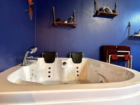 Honeymoon House | Bathroom | Bathtub, jetted tub, hair dryer, towels