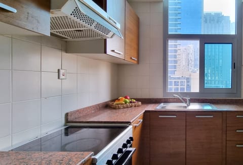 Full-size fridge, highchair, cookware/dishes/utensils, cleaning supplies