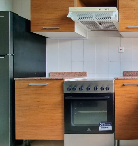 Full-size fridge, highchair, cookware/dishes/utensils, cleaning supplies