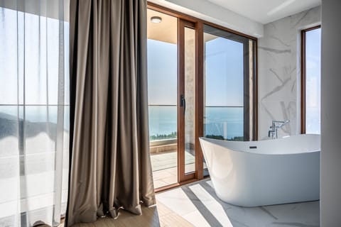 Cape View Villa | Bathroom | Separate tub and shower, hydromassage showerhead, hair dryer, bathrobes