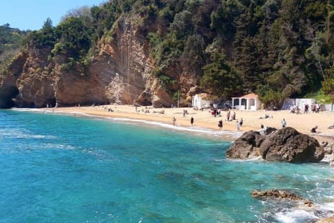 On the beach, white sand, beach cabanas, sun loungers