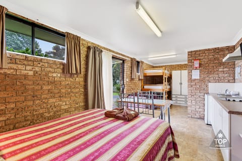 Standard Suite, 1 Bedroom, Non Smoking, Kitchenette (s/c villa 1 queen and 3 bunks) | Iron/ironing board, free WiFi, bed sheets