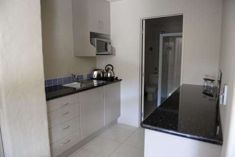 Deluxe Studio Suite, Kitchenette (Gold Suite) | Private kitchen | Fridge, microwave, coffee/tea maker, electric kettle