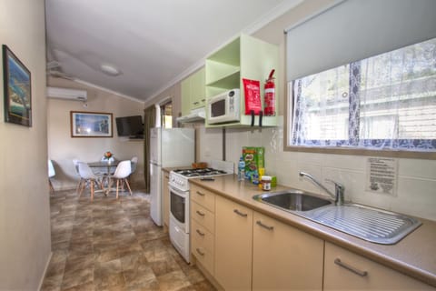 Wattle Spa Cabin | Private kitchen | Fridge, electric kettle, toaster, dining tables