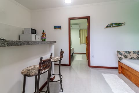 Economy Apartment, Poolside | Living area | Flat-screen TV