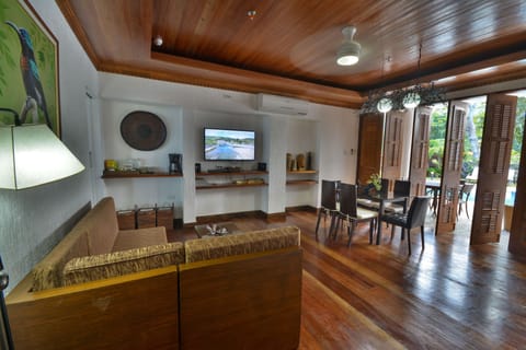 Suite, Beachfront (Daluyon) | Living area | 32-inch Smart TV with satellite channels, books